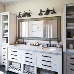 a bathroom with two sinks and mirrors in it