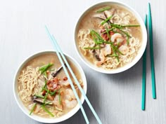 two bowls of soup with chopsticks on the side