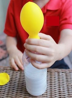 a young boy holding a yellow plastic spoon