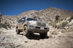 a truck is driving through the rocky terrain