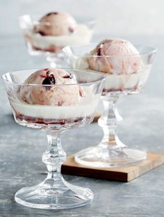 three glasses filled with ice cream on top of a table