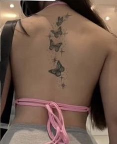 the back of a woman's body with butterflies on it