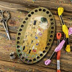 a pair of scissors sitting on top of a wooden table next to an art object