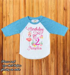 "Flamingo birthday shirt, flamingo family shirts, birthday girl flamingo shirt, first birthday outfit, baby girl birthday, baby girl H234 Wellcome to happy kid Customs!! : ) Please read all info before placing your order : ) This Design IS NOT MADE with glitter. -This listing is for a 3/4 colored sleeve/white body OR White short sleeve personalized shirt, we carry different sizes. ( Please make sure to select the same type of shirt you are purchasing on both drop down menus if you select a short Pink Summer Tops With Name Print, Pink Birthday Shirt For Summer, Pink Summer Birthday Shirt, Playful Pink Tops For First Birthday, Long Sleeve Summer Shirt For Birthday, Long Sleeve Summer Tops For Birthday, Personalized Pink Tops For First Birthday, Personalized Pink Top For First Birthday, Playful Pink Top For First Birthday