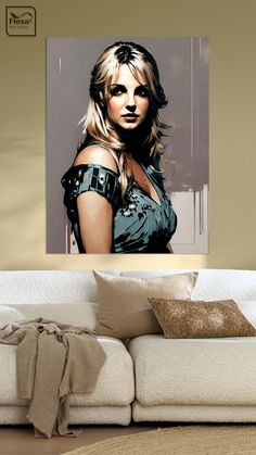 a painting of a woman with blonde hair on a wall above a couch in a living room