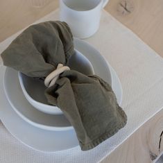 the napkins are folded on top of the dishes