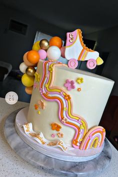 Peach, Yellow, Pink, White and Orange Striped Skate Party Birthday Cake with a Rainbow and Chocolate Spheres Groovy Birthday Desserts, Roller Skating Party Cupcakes, Groovy Skate Birthday Party, Rolling Into 10 Birthday Party, Roller Skating Cakes, Roller Skates Cake