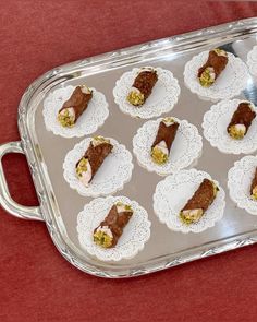 a tray filled with cupcakes on top of a red table