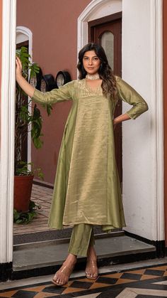 Green Golden Tissue Chanderi Anarkali Kurta Set, Kurta pant set Anarkali dresses, Indian wedding outfit Bring on the festive spirit with our anarkali kurta set in pure tissue and chanderi silk. Panelled Anarkali Kurta with separate inner and matching cotton silk pants. Kurta Fabric : Pure Tissue + Chanderi Silk. Pants : Cotton Silk. Dupatta : Pure Tissue. Colour : Light Green. Model height is 5.6" and is wearing a size S. Wash Care : Dry Clean Only. This product will be exclusively handcrafted f Festive Tissue Silk Palazzo Set For Diwali, Festive Tissue Silk Churidar With Straight Kurta, Festival Tissue Silk Straight Kurta, Eid Tissue Silk Straight Kurta, Pista Green Anarkali Kurta With Dupatta, Anarkali Kurta In Pista Green With Dupatta, Anarkali Kurta With Dupatta In Pista Green, Anarkali Style Floor-length Pista Green Palazzo Set, Tissue Silk Palazzo Set With Traditional Drape For Eid