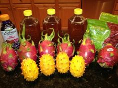 there are many different types of fruit on the counter top, including pineapples and bananas