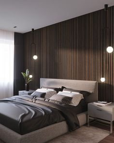 a large bed in a bedroom next to a window with wooden slats on the wall