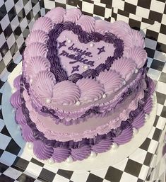 a heart shaped cake sitting on top of a checkered table