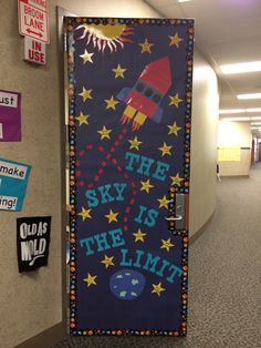 the sky is the limit door decoration in an office hallway with space shuttle on it