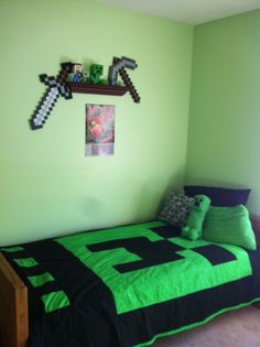 a bedroom with green walls and a black bedspread on top of the bed