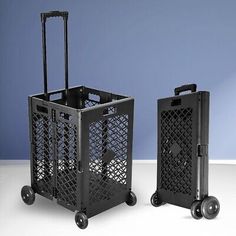 two black shopping carts sitting next to each other on a white table with blue background