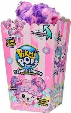 pink and purple pom poms in a box