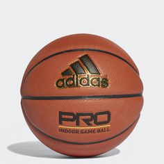 an adidas pro basketball is shown on a white background in this image, the ball has gold lettering