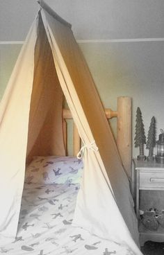 a bed with a teepee on top of it