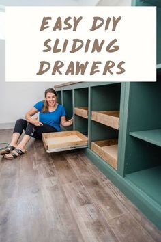 a woman sitting on the floor next to some shelves