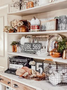 an old fashioned typewriter and other items on a shelf