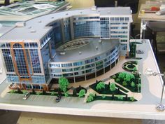 a model of a building with cars parked in front