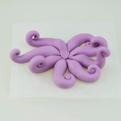 an octopus sculpture sitting on top of a piece of paper