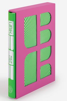 a pink book with green and white designs on it