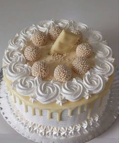 a cake with white frosting and decorations on top