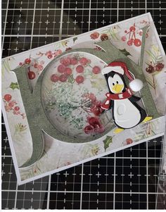 a penguin is standing next to a plate with cherries on it and another card in the background