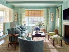 a living room filled with furniture and a flat screen tv mounted on the wall above a fireplace