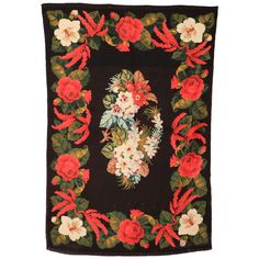 a black wall hanging with red and white flowers