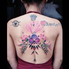 the back of a woman's body with flowers and hearts painted on her chest