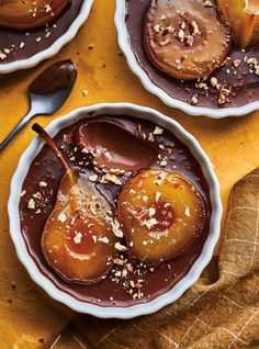 two bowls filled with caramel and chocolate desserts on top of a yellow cloth