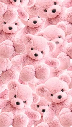 a large group of pink teddy bears with black eyes