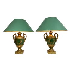 pair of green and gold urn lamps with shades on each lamp, side by side