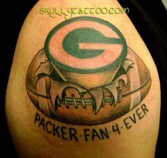 a green bay packers fan has tattoos on his arm and shoulder that reads,'i am the packers super fan 4 ever '