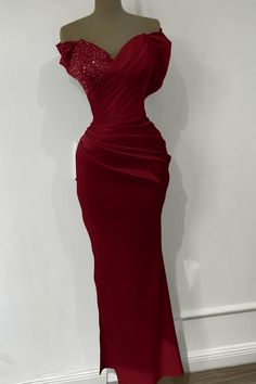 a mannequin wearing a red dress with sequins on it