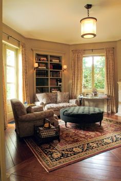 a living room filled with furniture and a fire place next to a large open window