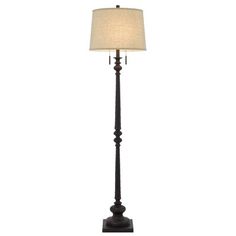 a floor lamp with a white shade on it's side and a black base