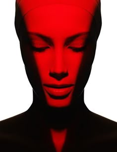 a woman with her eyes closed in red light