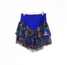 Fab 1980s - 1990s vibrant blue to near purple Ra-Ra style skirt with two black floral chiffon layers over a black lining. Fastens at the back with a zip and a slightly elasticated back. Dry cleaned prior to listing. Available on layaway, Please DM us for details. Measurements: - 28-30" Waist - 40" Hip - 17" Length at the side Description: Vintage Skirt in Excellent Condition.  There is no original label but we estimate the material to be polyester and rayon.. How we measure our garments: * Shoul Vintage Rock, Floral Chiffon, Vintage Skirt, Black Floral, Skirt Fashion, Womens Skirt, Vintage Outfits, Mini Skirts, Chiffon