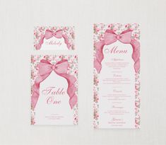 the wedding stationery is decorated with pink flowers and bows