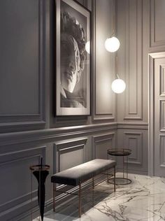 an elegant room with marble floors and white walls, along with art work on the wall