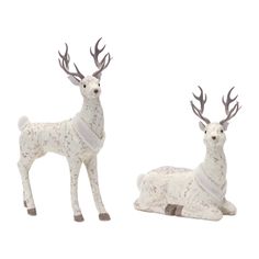 two white deer figurines sitting next to each other