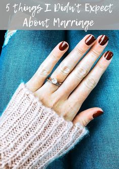 a woman's hand with brown and white nail polish on her nails sitting in a car seat