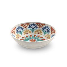 a white bowl with an orange and blue flower design on the bottom, sitting on a white surface