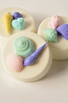 three seashells are sitting on top of soap