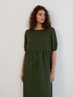 ESME is a relaxed-fitting, midi-length linen dress with charming puff sleeves and a flattering gathered bodice that sits at an empire waist. DETAILS - Relaxed, loose-fitting silhouette - Empire waistline with gathered skirt - Round neckline - Short puff sleeves with elasticated hems - Midi length COLOR - Forest Green (featured color) - Multiple colors available in dropdown menu above - See all color options & order fabric samples here: https://www.etsy.com/listing/586569696/linen-fabric-samples Green Linen Knee-length Midi Dress, Green A-line Linen Midi Dress, Knee-length Linen Dress With Gathered Sleeves, Relaxed Fit A-line Linen Dress, Green V-neck Linen Dress, Empire Waistline, Linen Midi Dress, Gathered Skirt, Style Expert