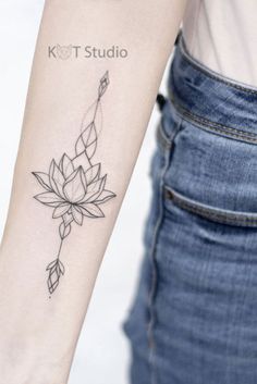 a woman's arm with a lotus tattoo on the left side of her arm