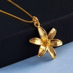 "Gold Lily Flower Pendant Necklace, 24k Gold Vermeil Style Lily and Gold Filled Chain, Mothers Day Jewelry Gift, Anniversary Necklace, FREE SHIPPING This high polished Vermeil style 24 karat gold lily pendant has an elegant and detailed floral design. The lily pendant can be matched with your choice of 14 karat gold filled chain. What is Vermeil Style? Gold vermeil jewelry refers to gold plated over 925 sterling silver. To be considered Vermeil the gold layer must be at least 2.5 microns thick.  Gold plated jewelry has a thin gold layer of at least 0.5 microns over an inexpensive base metal such as copper or brass. Like gold vermeil jewelry, vermeil style jewelry is layered over 925 sterling silver. Vermeil style also has twice the thickness of gold layer (1.0 micron) than gold plated jewe Lily Flower Jewelry, Lily Flower Necklace, Gold Flower Pendant Necklace For Anniversary, Gold Flower Necklace For Anniversary, Gold Flower Pendant Necklace Gift For Her, Gold Flower Necklace As Gift For Her, Gold Flower Necklace For Her, Gold Flower Necklace Gift For Her, Gold Flower Pendant Necklace For Mother's Day